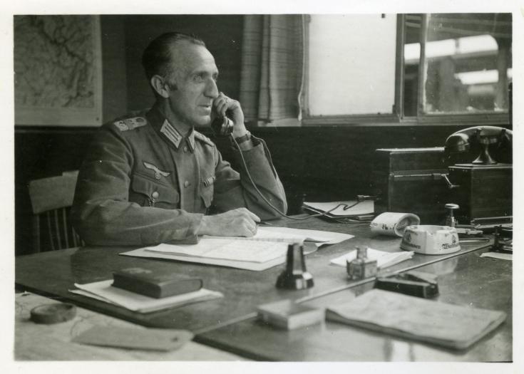 A German officer in a Belgian office at Mons railway station. The Wehrmacht Verkehrs Direktion aggressively takes over large parts of SNCB's strategic and operational business management. Source: private collection Paul Pastiels.